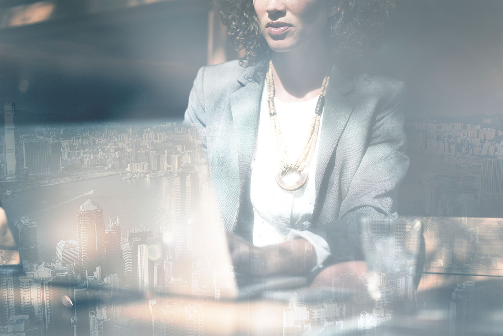 Businesswoman with a city skyline double-exposure overlay