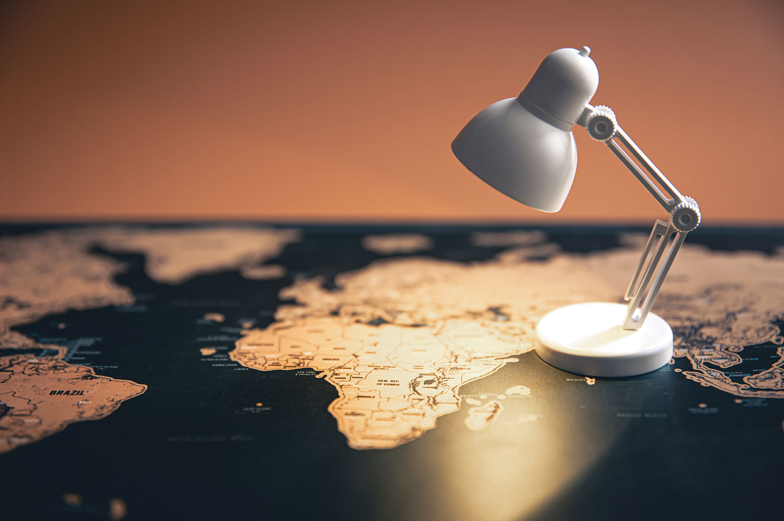 Desk lamp illuminating a world map