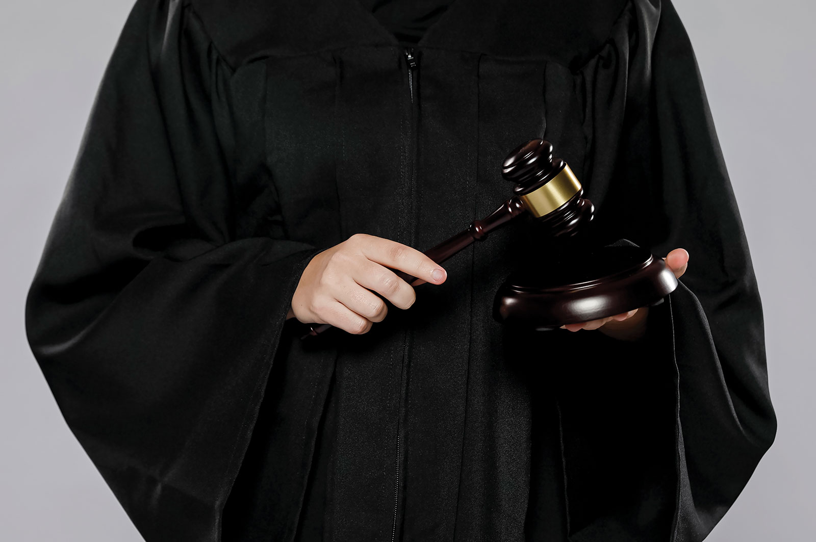 Judge in black robes holding a gavel